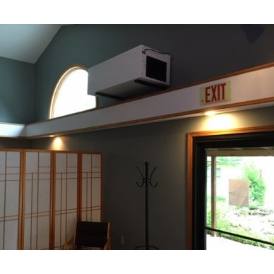 BSE AIRPRO Carbon 1100 CFM Commercial Ambient Air Cleaner mounted on a wall above an exit sign.