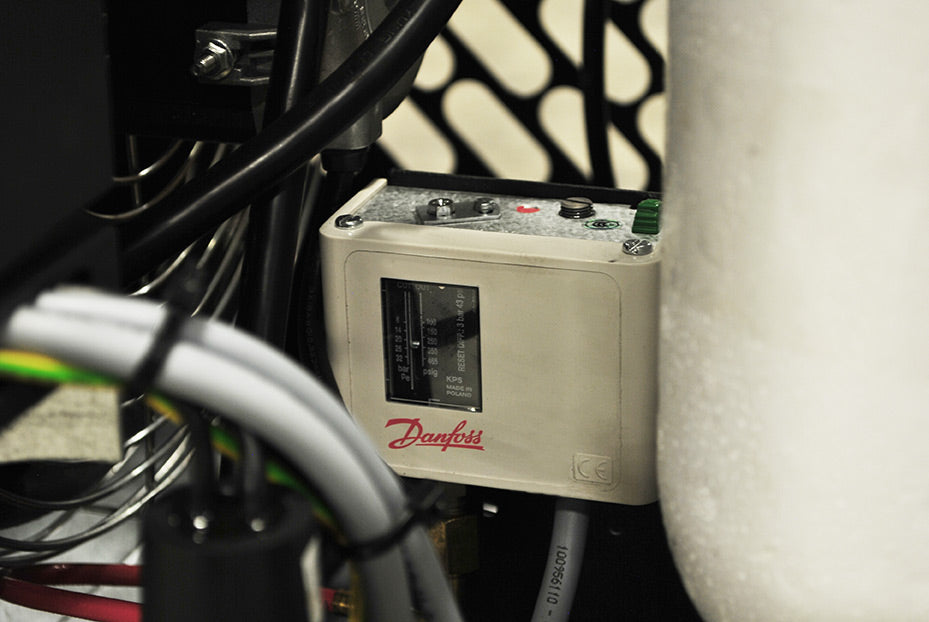  Interior view showing the components of the Airbase by Emax 144CFM air dryer, including pipes and compressor