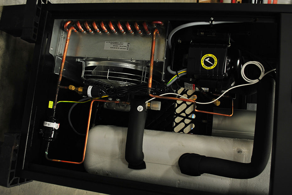 Top-down internal view of the EMAX EDRCF1150115 air dryer, displaying the copper piping, refrigerant tank, and compressor unit.
