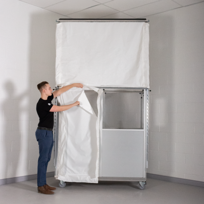 Technician opening AG5000 side wall access panel on AIRE GUARDIAN containment enclosure
