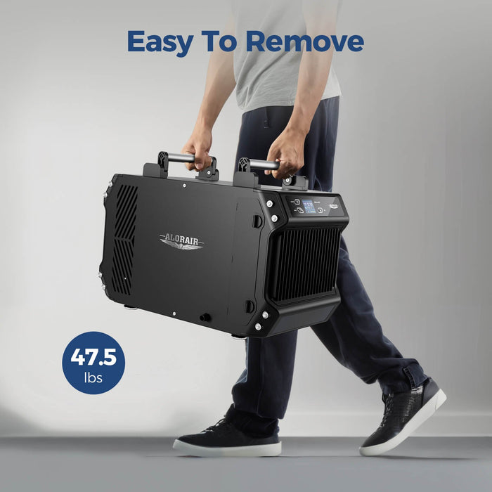 Person carrying the lightweight 47.5 lb AlorAir Galaxy 60 dehumidifier by its dual handles