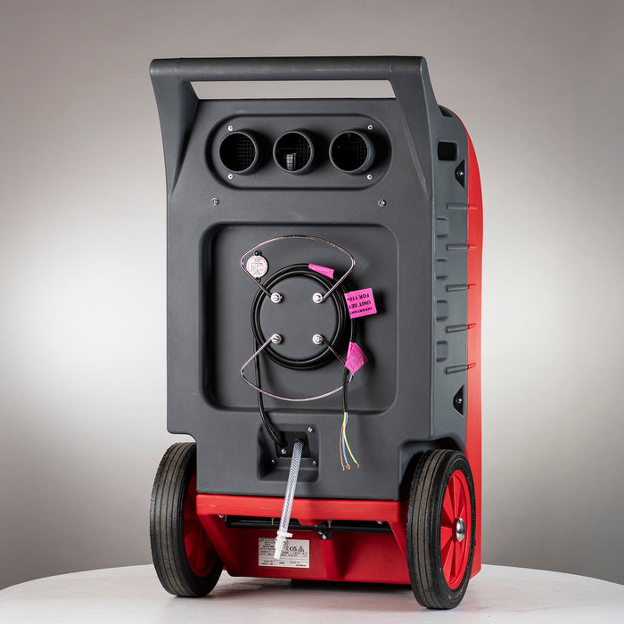 Rear view of EBAC RM85 industrial dehumidifier showing drain hose connection, rear vents, power cable, and wheeled base