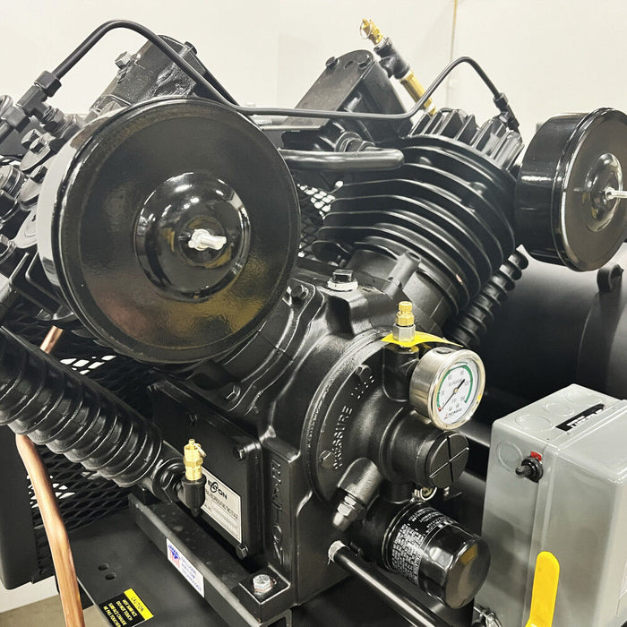 Close-up of pressure-lubricated piston pump and gauge on EMAX E450-DR Series duplex air compressor