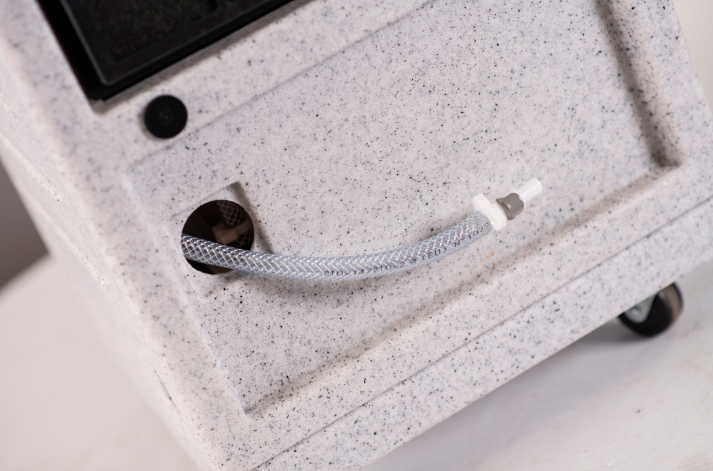 Rear drain hose connection on EBAC RM40P compact industrial dehumidifier with permanent drainage outlet