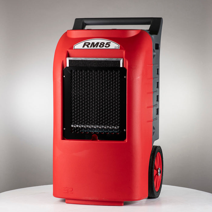 Front view of RM85 EBAC commercial dehumidifier with air intake grille, rugged housing, handle, and transport wheels