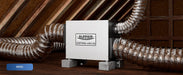 AlorAir Sentinel WHD100 whole house dehumidifier hanging installed in an attic with insulated ductwork