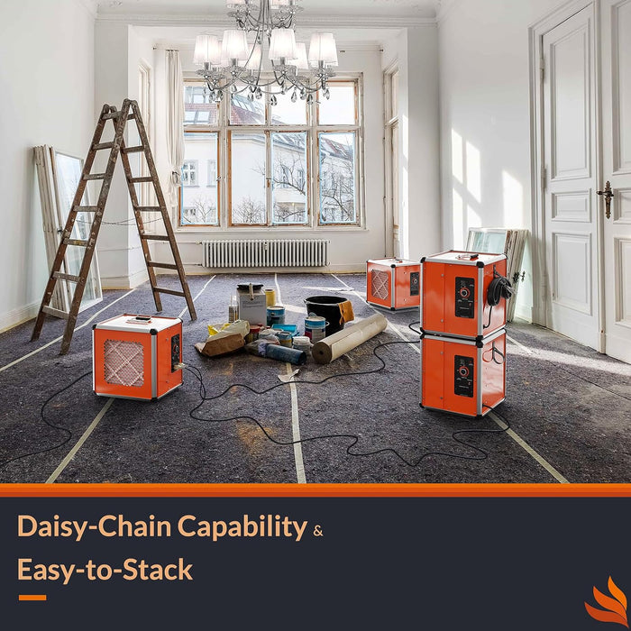 Three orange HEPA 600 UVIG air scrubbers stacked and daisy-chained in a renovation room, showing multi-unit setup for large job sites