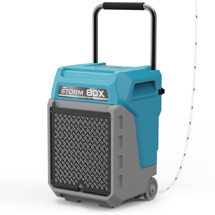 AlorAir Storm 80X commercial dehumidifier in blue, shown at an angle with drain hose attached