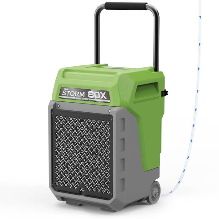 AlorAir Storm 80X commercial dehumidifier in green, shown at an angle with drain hose attached