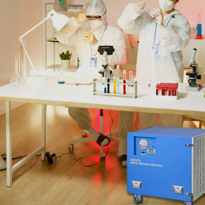 Two people in a lab wearing a white protective suit with an Airrex Portable Air Scrubber HSC-HEPA2000.